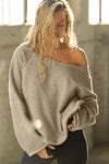 Front view of model posing in the oversized sand french terry Slouchy Pullover Sweatshirt with a wide, off-the-shoulder neckline and a JOAH BROWN logo patch on the right sleeve