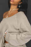 Close up side view of model posing in the oversized sand french terry Slouchy Pullover Sweatshirt with a wide, off-the-shoulder neckline and a JOAH BROWN logo patch on the right sleeve