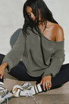 Front view of model posing in the oversized washed sage french terry Slouchy Pullover Sweatshirt with a wide, off-the-shoulder neckline and a JOAH BROWN logo patch on the right sleeve