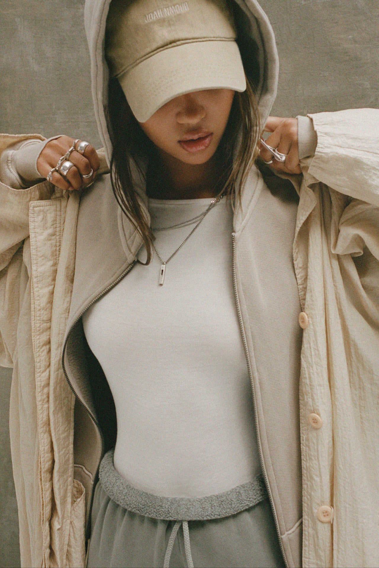 Front view of model wearing the six-panel desert Official Cap with a curved brim and an embroidered upside down Joah Brown logo on the front