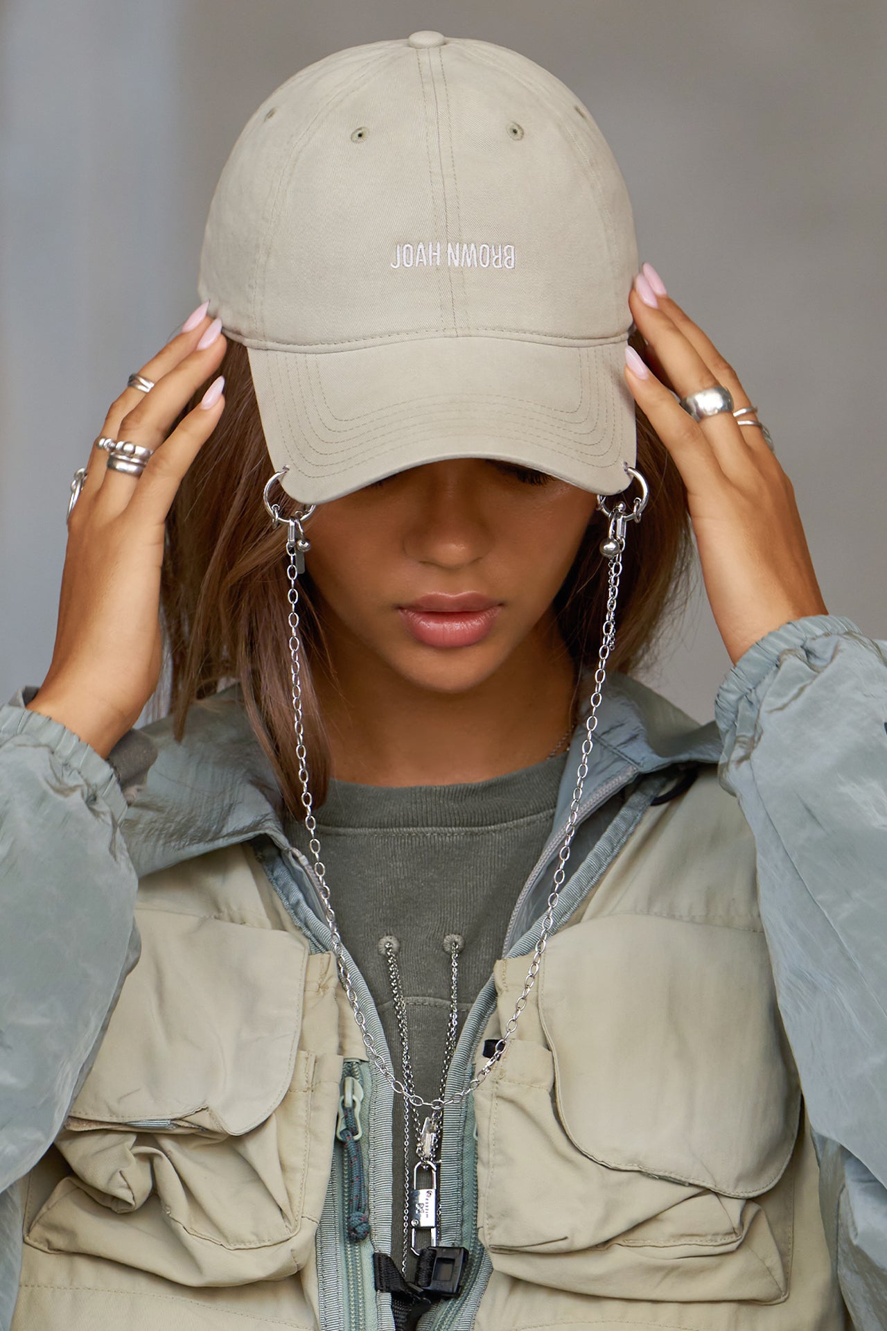 Front view of model wearing the six-panel sahara Official Cap with a curved brim and an embroidered upside down Joah Brown logo on the front