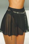 Close up side view of the mini black mesh skirt with an adjustable waist tie
